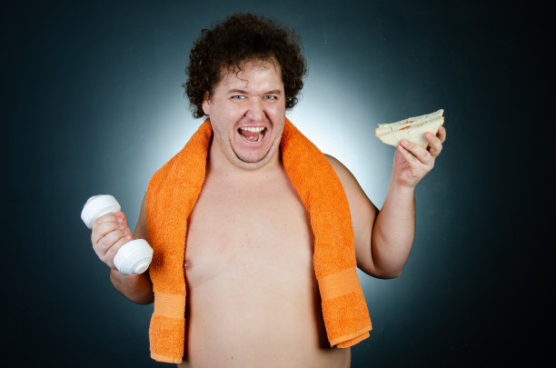 节食的滑稽胖子。健康的生活方式和运动。图片下载