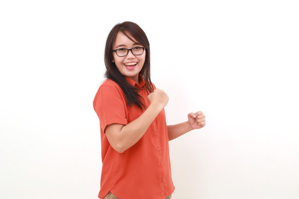 兴奋的年轻亚洲女子用拳头庆祝她的成功。孤立于白色图片下载