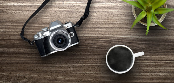 从上面看，桌子上有照相机和咖啡——工作或度假准备的概念图片下载