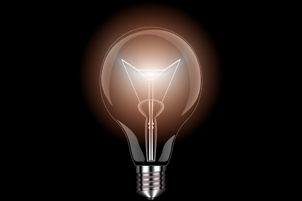 玻璃灯泡在透明的黑色背景与明亮的黄色辉光。图片下载