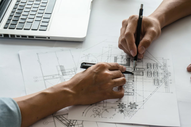 建筑项目的建筑图纸商业建筑建筑施工同事室内设计师企业规划设计图纸用圆规团队合作。图片下载