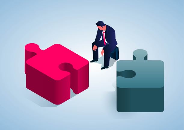 分裂和破产，失意的商人坐在分裂的拼图旁边图片下载