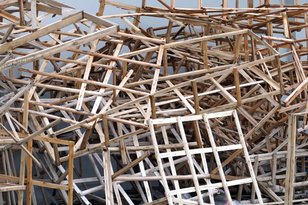 建筑工地，水泥墙旁边的一堆木棍作为纹理和背景。图片下载