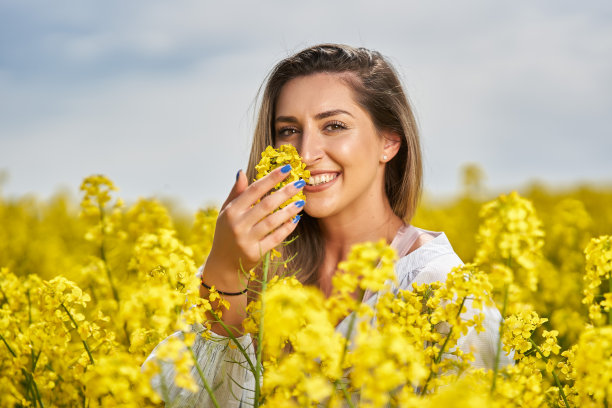 美丽的金发拉丁女人在油菜地里图片下载