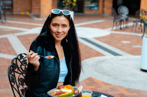 吃哥伦比亚食物的年轻女子图片下载