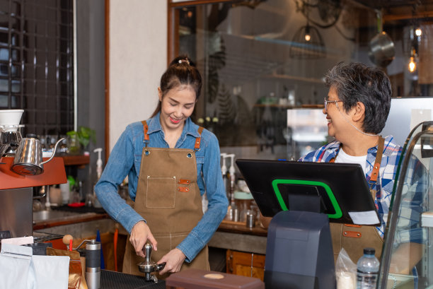 亚洲可爱的老人，老人，退休，女人。母亲和女儿在她的咖啡店工作。小企业，企业主。图片下载