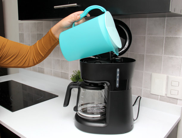 女人的双手在厨房的咖啡机里用清水和现磨咖啡为早餐准备美味而芳香的咖啡图片下载