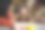 一男一女躺在地板上看着他们六个月大的女儿学着爬。儿童早期发展概念图片下载