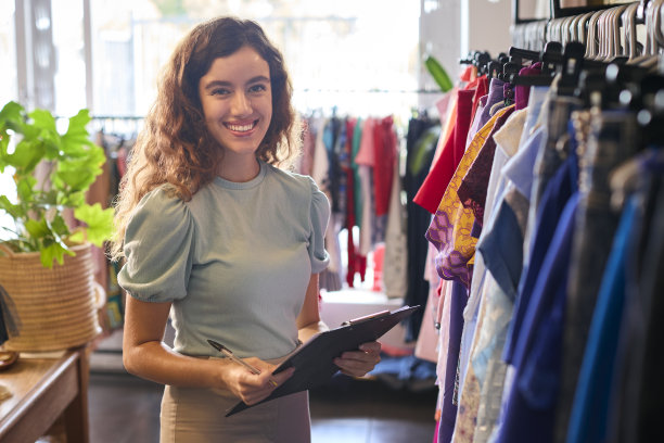 时尚服装店的女老板或工人用剪贴板检查库存的肖像图片下载