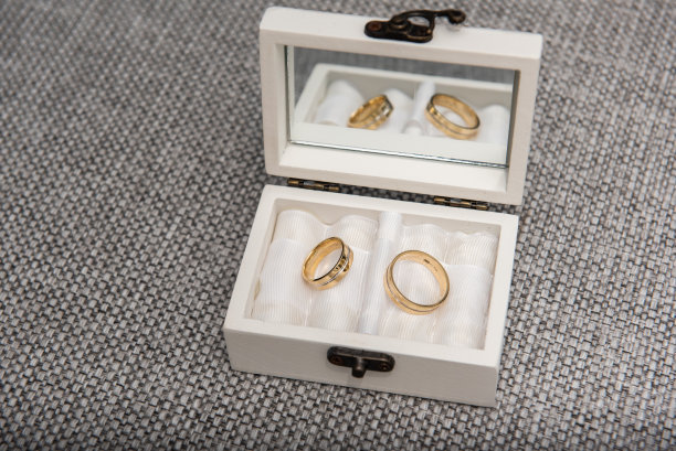 新娘和新郎的结婚戒指放在一个白色的木盒里图片下载