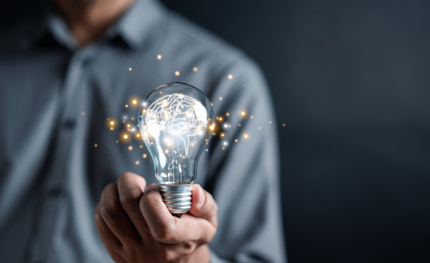 男人手捧电灯泡开始新的想法和学习教育和毕业理念。学习企业战略中的创新思维和解决问题的方法。图片下载