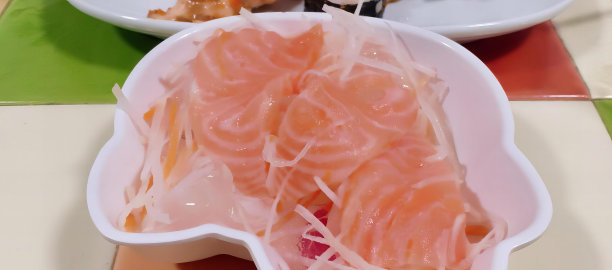 一盘食物与叉子和一碗食物的照片，一盘食物与一块鲑鱼和一侧沙拉。图片下载