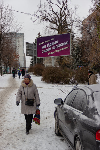 雪覆盖的城市景观与广告牌广告竞选活动的总统的乌克兰。文本:军队!语言!信仰!我们走自己的路!秘书波罗申科图片下载