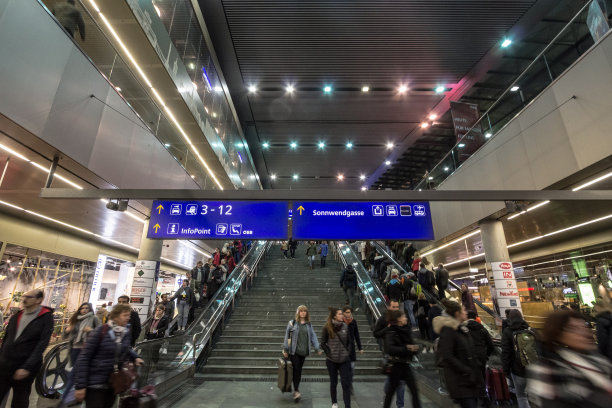 在维也纳中央火车站，人们爬楼梯和自动扶梯，而乘客们则蜂拥着去赶火车。图片下载