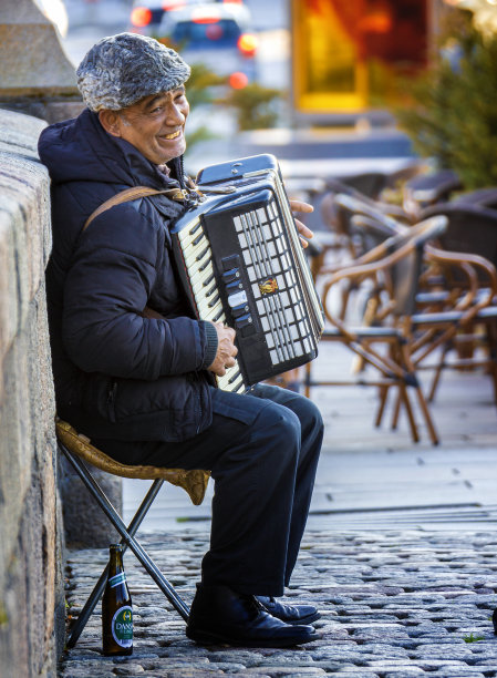 微笑的街头音乐家演奏手风琴图片下载