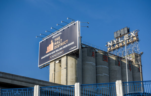 奈莱克斯时钟在一系列旧混凝土筒仓上方图片下载