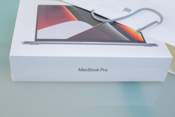 苹果MacBook Pro 14 M1 Pro 2021笔记本电脑开箱。新的笔记本电脑在苹果包装在家里的桌子上。网上购物的概念图片下载