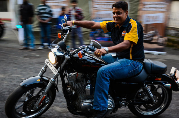 运动模糊摇摄照片的男子骑着哈雷戴维森摩托车在路上。运动自行车在街道上的模糊运动和速度的概念。图片下载