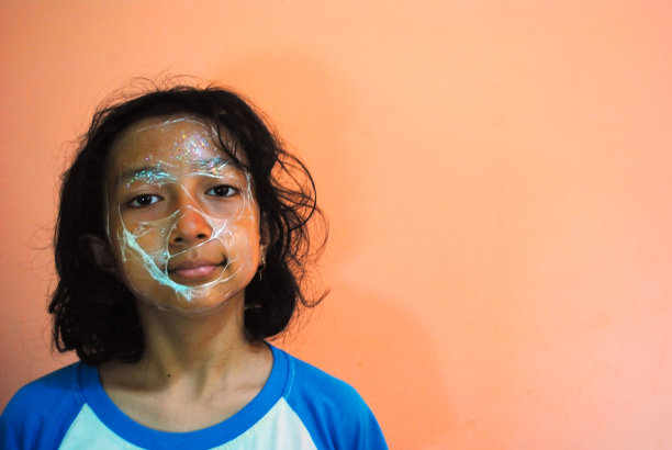 模特的怪脸。一个戴着塑料面具的女孩的孤立图像。独特的照片模型。图片下载