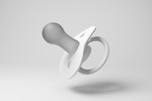 白色婴儿奶嘴(英国:假人)漂浮在半空中，白色背景单色和极简主义。说明婴儿产品的概念和与婴儿相关的主题图片下载