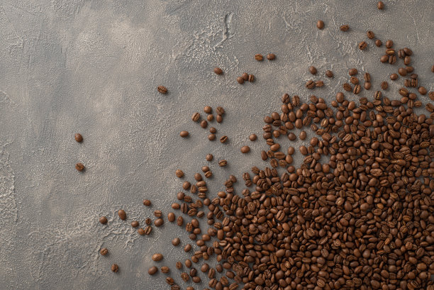 深色烘焙幻想:俯视图照片，在丰富的深灰色垃圾背景上散落的咖啡豆，完美的广告图片下载