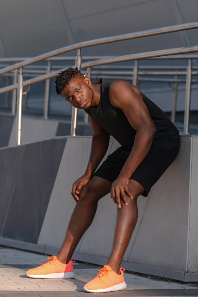 穿着运动服的疲惫的非洲男子在户外剧烈运动训练后休息的全身照片图片下载