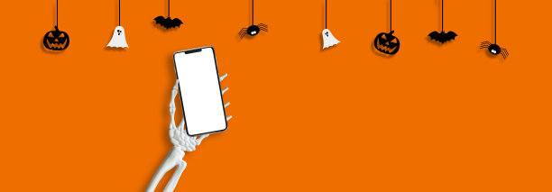 万圣节之夜，骷髅手拿着手机图片下载