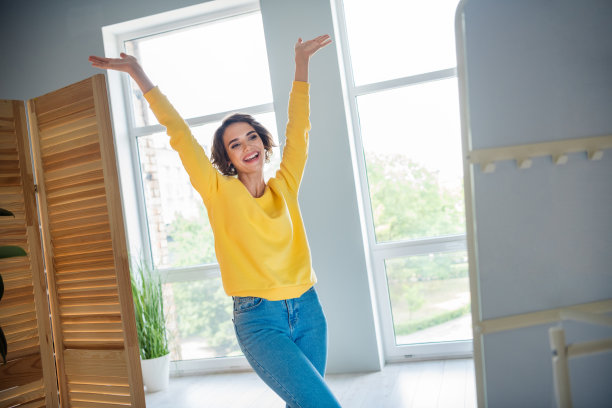 照片积极开朗的女士举起双手照镜子享受她的新面貌在家里买衣服的公寓图片下载