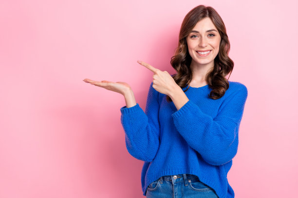 照片正面可爱的女孩穿蓝色衣服手臂直接空的空间黑色星期五折扣孤立在粉红色的背景图片下载