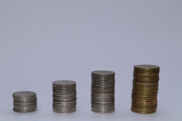 一堆硬币放在一个原始的白色背景上，描绘了典型的储蓄理念。这张迷人的图片抓住了财政责任和未来规划的本质图片下载