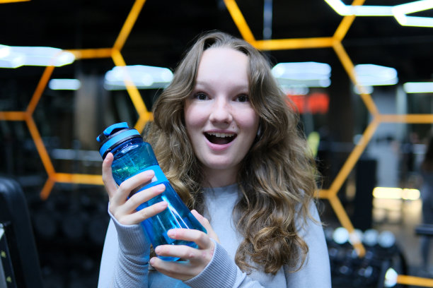 照片集蛋白质。从厕所更衣室到健身房的过程。女子在健身房健身训练用哑铃健身运动，运动员锻炼肌肉图片下载