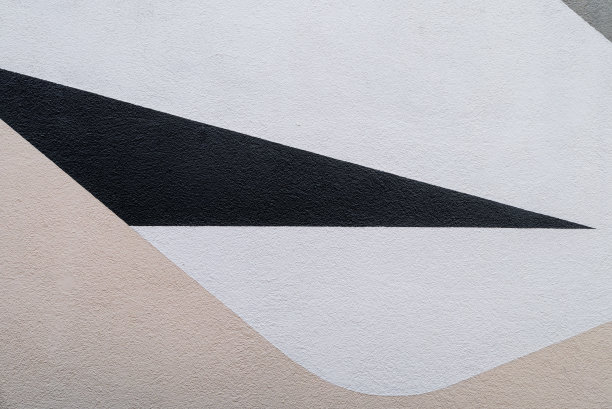一面墙的抽象照片，在白色和米色场周围有一个尖锐的三角形黑色场图片下载