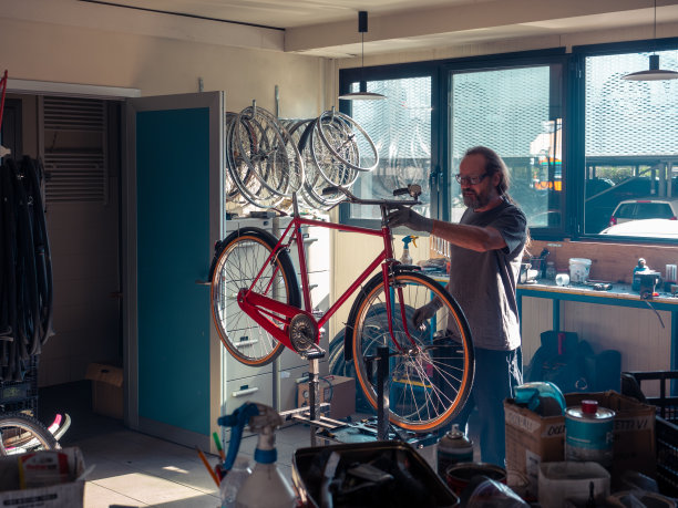在自行车店存放和修理，机械师修理修复和毁坏自行车图片下载