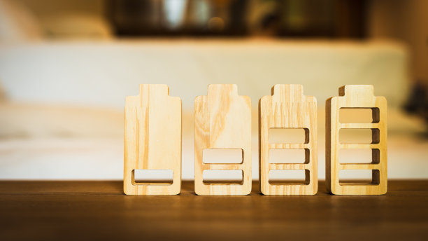 电池充电指示器木质模型。手机电量水平。通过令人着迷的照片了解电池充电指示器的概念。释放这些数字图标的力量、技术和创新。图片下载