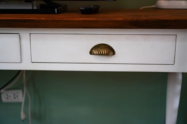 客厅里带有复古贝壳形抽屉把手的电视桌图片。图片下载