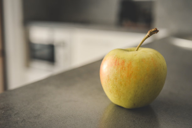 厨房里灰色的桌子上放着新鲜的青苹果。文本空间图片下载