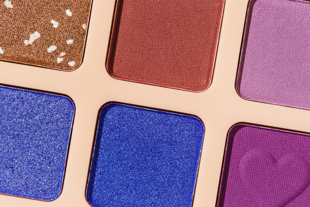 接近最小的图案与彩色眼影样品，趋势色板上的米色背景。眼影粉与闪光化妆，光泽和哑光，美学照片，俯视图图片下载