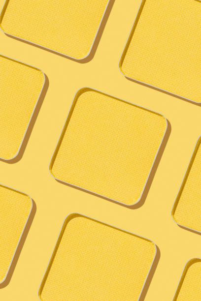 极简图案眼影黄色色板带阴影，单色照片背景，填充紧凑的眼影，闪亮的彩妆粉，方形金属包，化妆质感图片下载