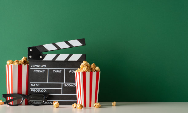 用美味的概念提升你的电影的发布。侧视图照片，桌子上装饰着制片人的电影拍板，3D眼镜，爆米花在绿色的墙壁背景，电影宣传的空间图片下载