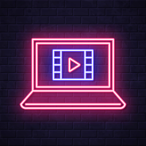 在笔记本电脑上看视频。在砖墙背景上发光的霓虹灯图标图片下载