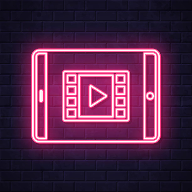 在平板电脑上观看视频。在砖墙背景上发光的霓虹灯图标图片下载