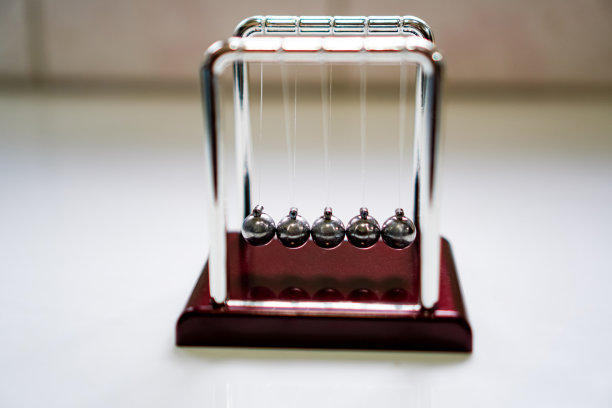 牛顿摇篮平衡球的图片，练习冥想时，在桌子上工作。图片下载