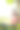 深棕色头发的女孩戴着白色耳机在公园的树下使用笔记本电脑图片下载