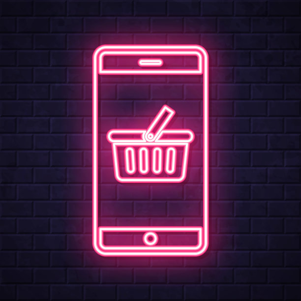 带购物篮的智能手机。在砖墙背景上发光的霓虹灯图标图片下载