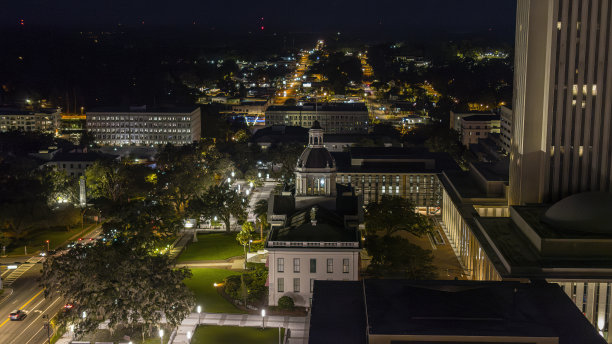 夜晚照亮塔拉哈西，佛罗里达州的天际线:州议会大厦在市中心的道路上。照片去噪和美化图片下载
