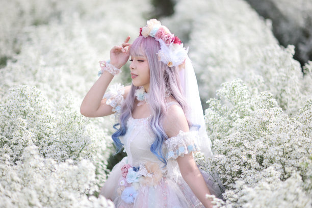 亚洲年轻女子的肖像与洛丽塔时尚服装在白色的花园背景图片下载