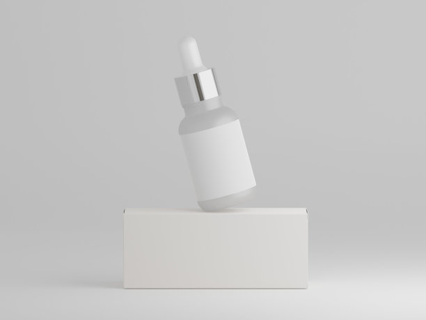 白色哑光滴管瓶平衡在其包装盒上图片下载