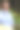 有魅力的成熟女人在公园里拄着北欧步行杆。一位老妇人走在公园的小巷里。穿蓝衬衫的黑发中年女性，笑得很开心。老年人积极的生活方式。图片下载