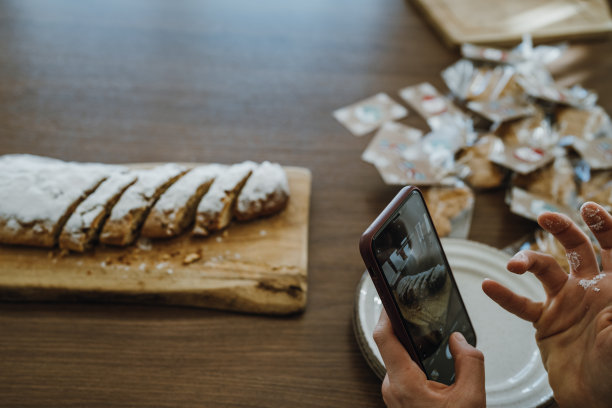 手拿智能手机为社交媒体拍摄水果蛋糕的照片。图片下载