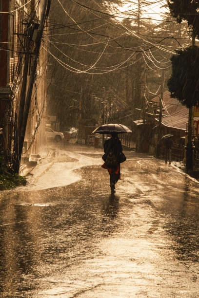 一个人在雨中行走的剪影——傍晚的雨图片下载